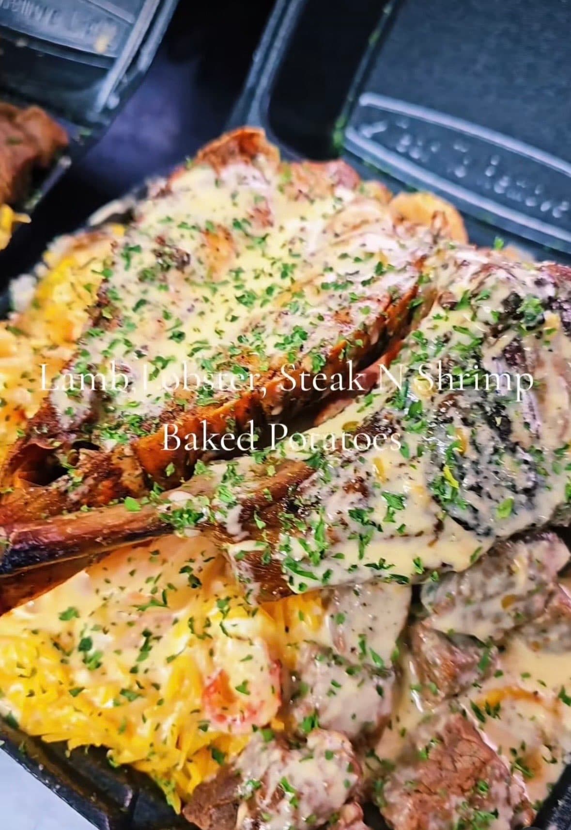 Boss Potato — lamb, lobster, steak, and shrimp over a loaded baked potato — Lil Moe's Potato Trap Houston